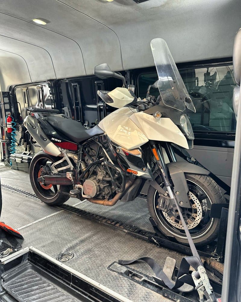 Motorcycle secured inside enclosed transport van