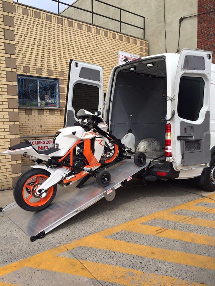 Motorcycle loaded up enclosed transport ramp
